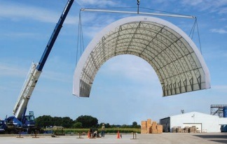Portable fabric structure held by a crane