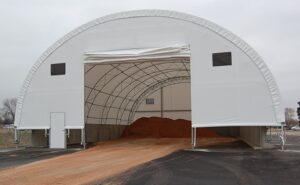 Photo of a fabric covered building with roll up flap on front.