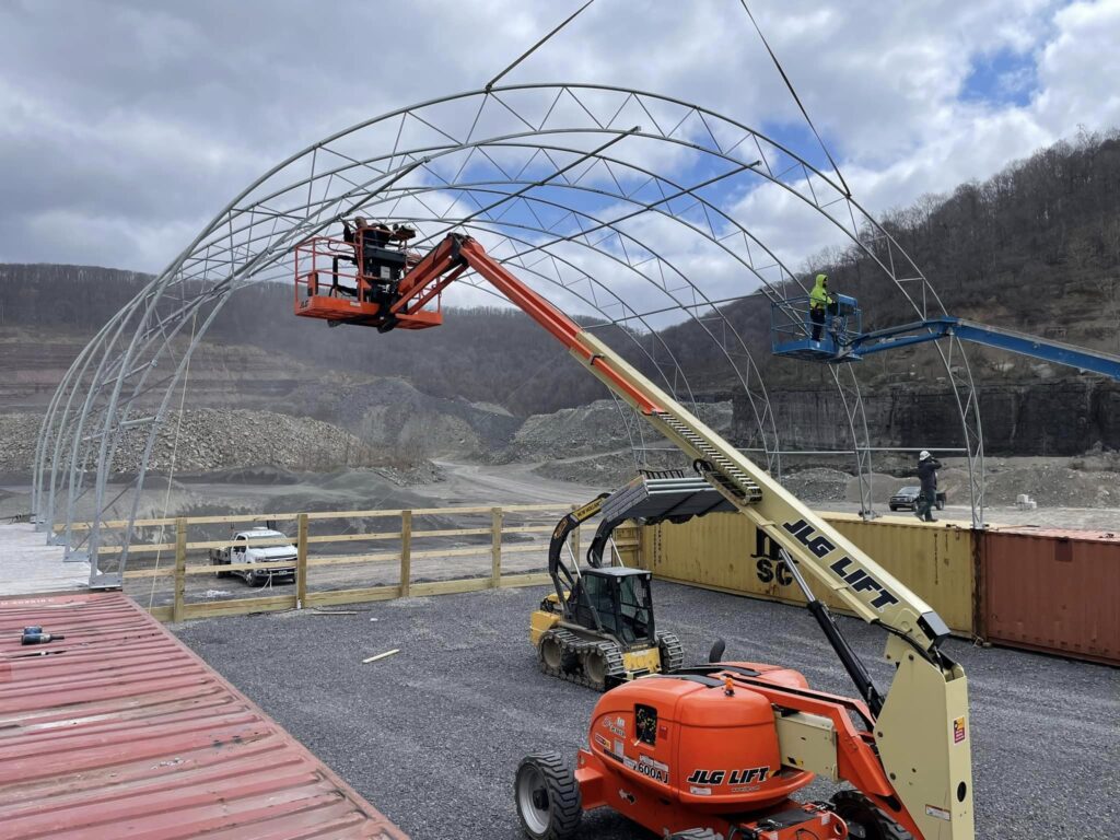 Accu-Steel dealer, Clint Iams from Log Cabin Fence Co located in Amity, PA put up an Advantage building (you might recognize this as a hoop building) in Morgantown, West Virginia. The foundation of this building is shipping containers! This building will be used for employees at the quarry to pull their equipment in and work while being protected from the elements. Accu-Steel fabric-covered buildings can also be relocatable, making them perfect for situations like this where work sites may move in the future. Learn more or get a free quote at AccuSteel.com